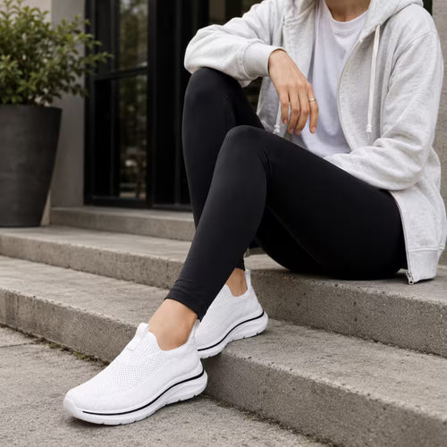 White knit slip-on sneakers with cushioned sole and low-profile design