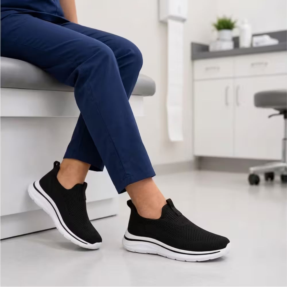 Black knit slip-on sneakers with cushioned sole and white edge trim
