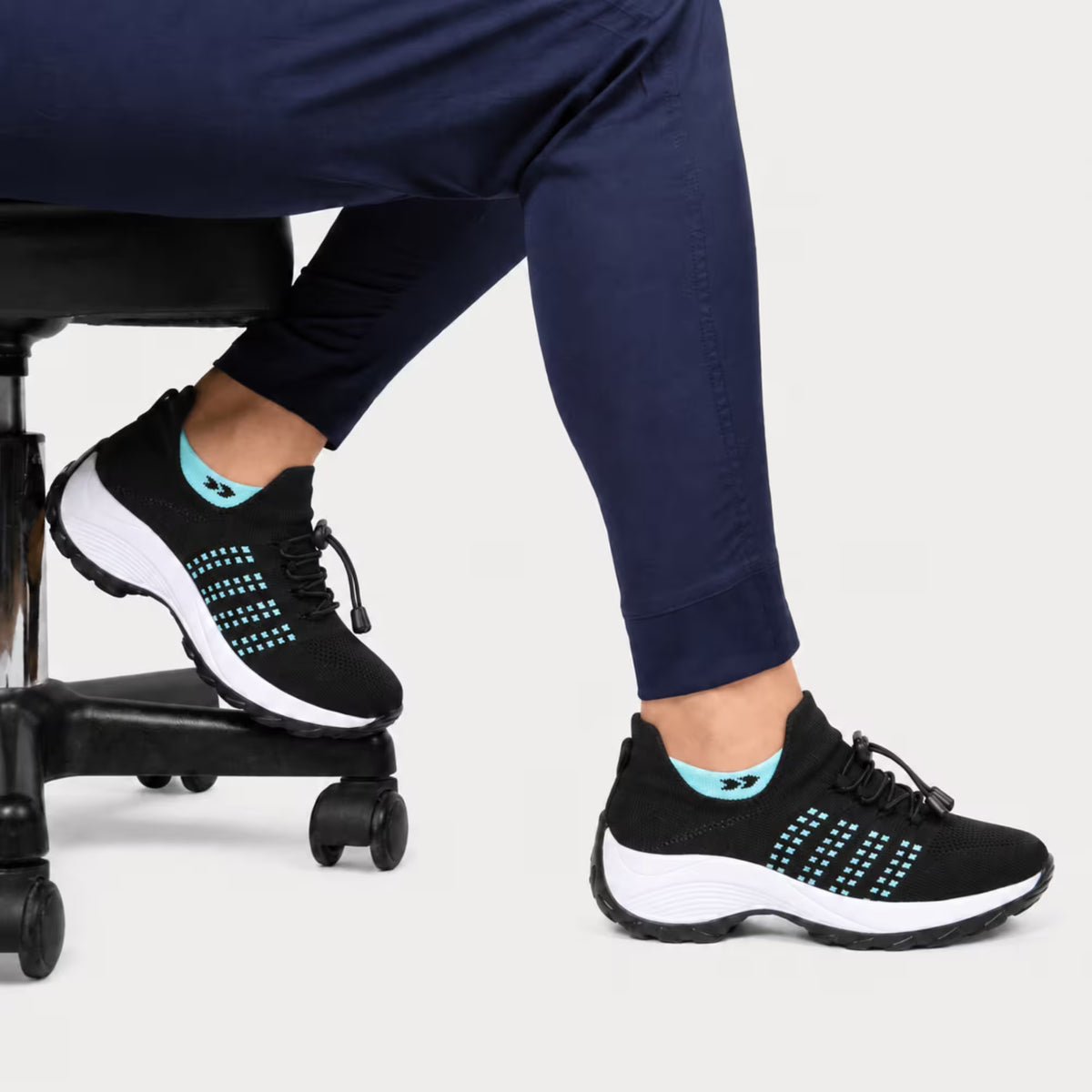 Black and aqua knit lace-up sneaker with white midsole and cushioned tread