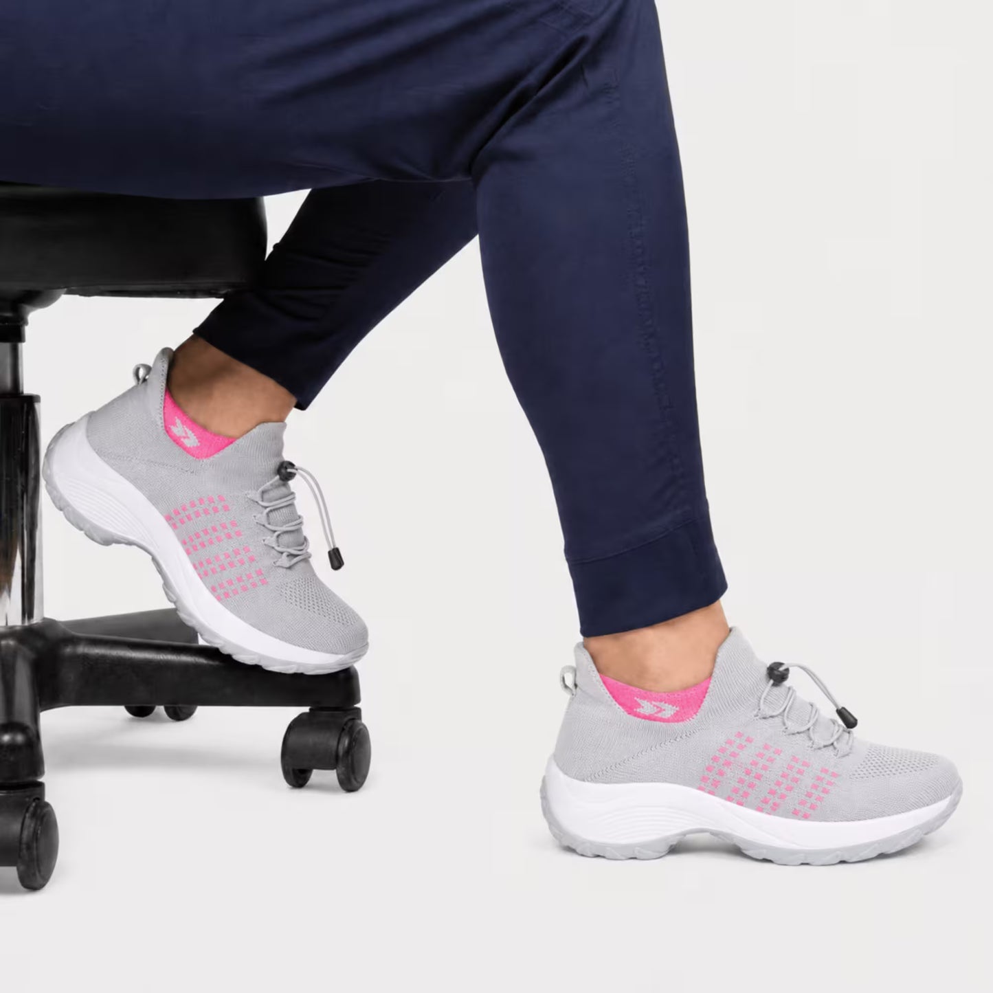 Light gray comfort sneaker with pink knit details, lace-up and cushioned sole